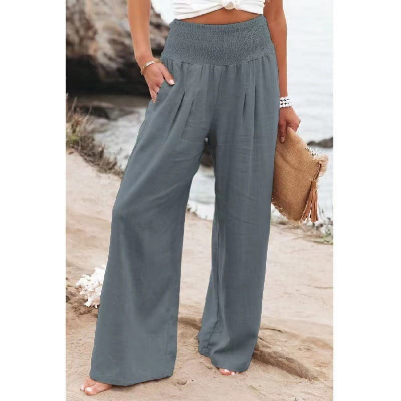 gray high-waisted wide-leg pants for women with a smocked waistband and side pockets in solid color fabric