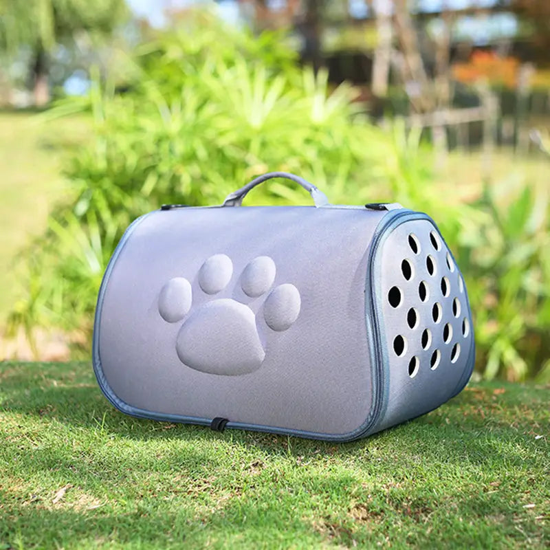 Eva folding pet carrier bag in gray featuring a raised paw print design and circular ventilation holes for airflow.