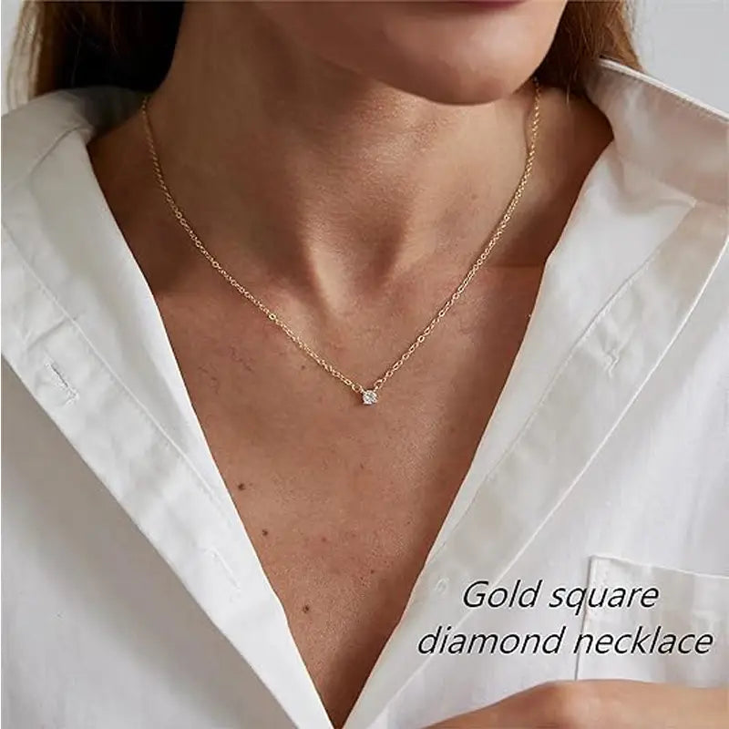 A delicate 14k gold plated dainty necklace with a small square cut diamond solitaire pendant.
