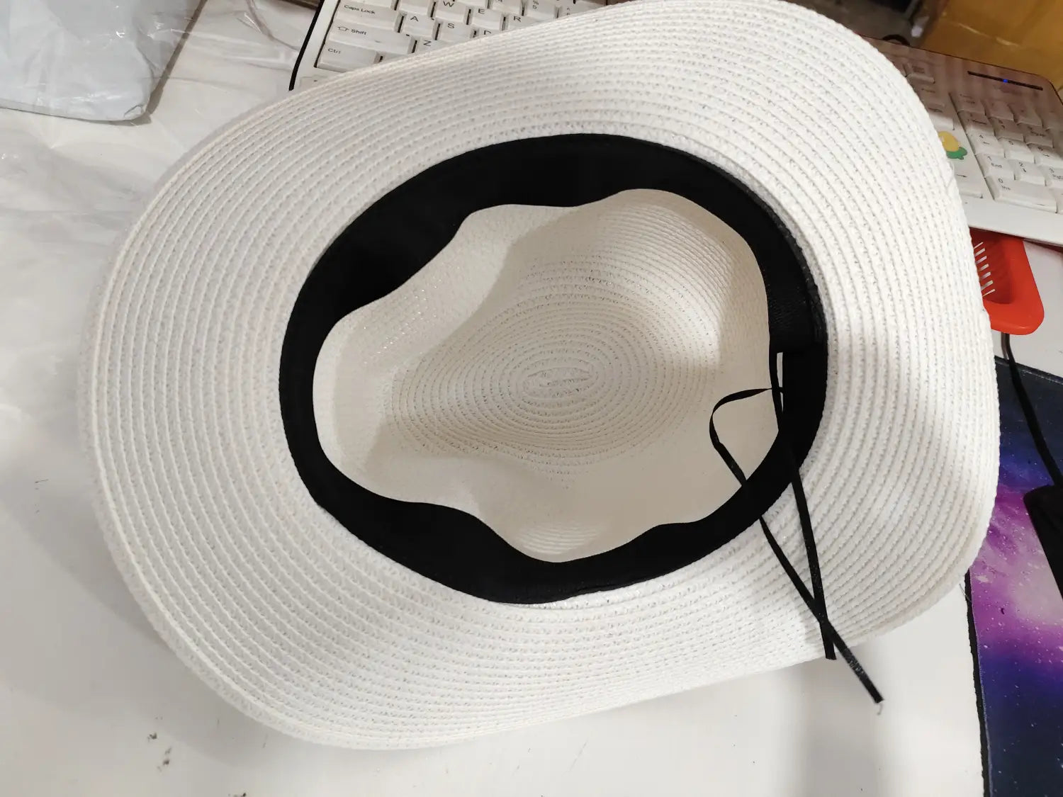White straw fedora hat with black band and matching black adjustable strap designed for foldable sun protection men.