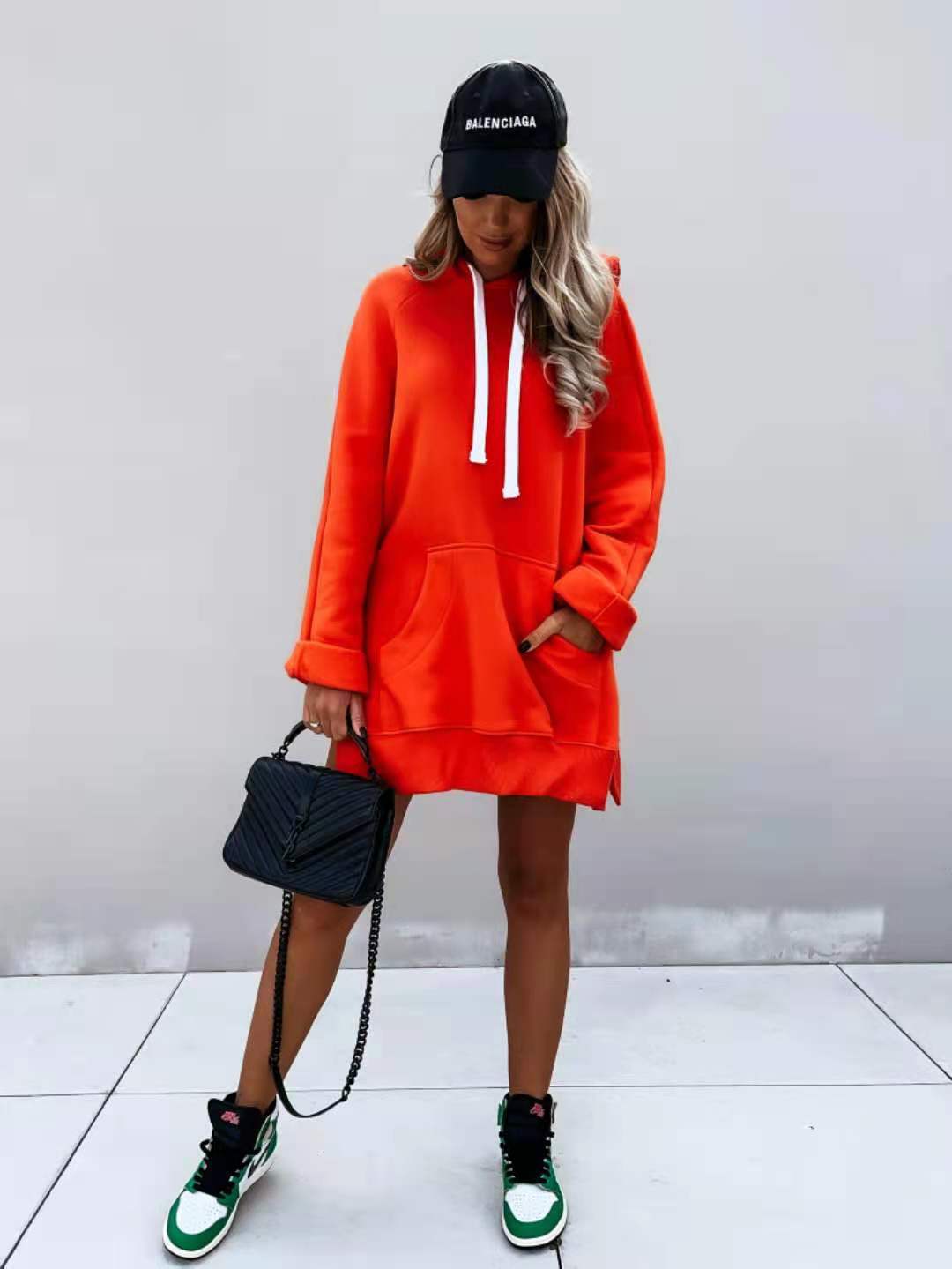 orange oversized mid length hooded sweatshirt dress with white drawstrings ribbed cuffs and pockets