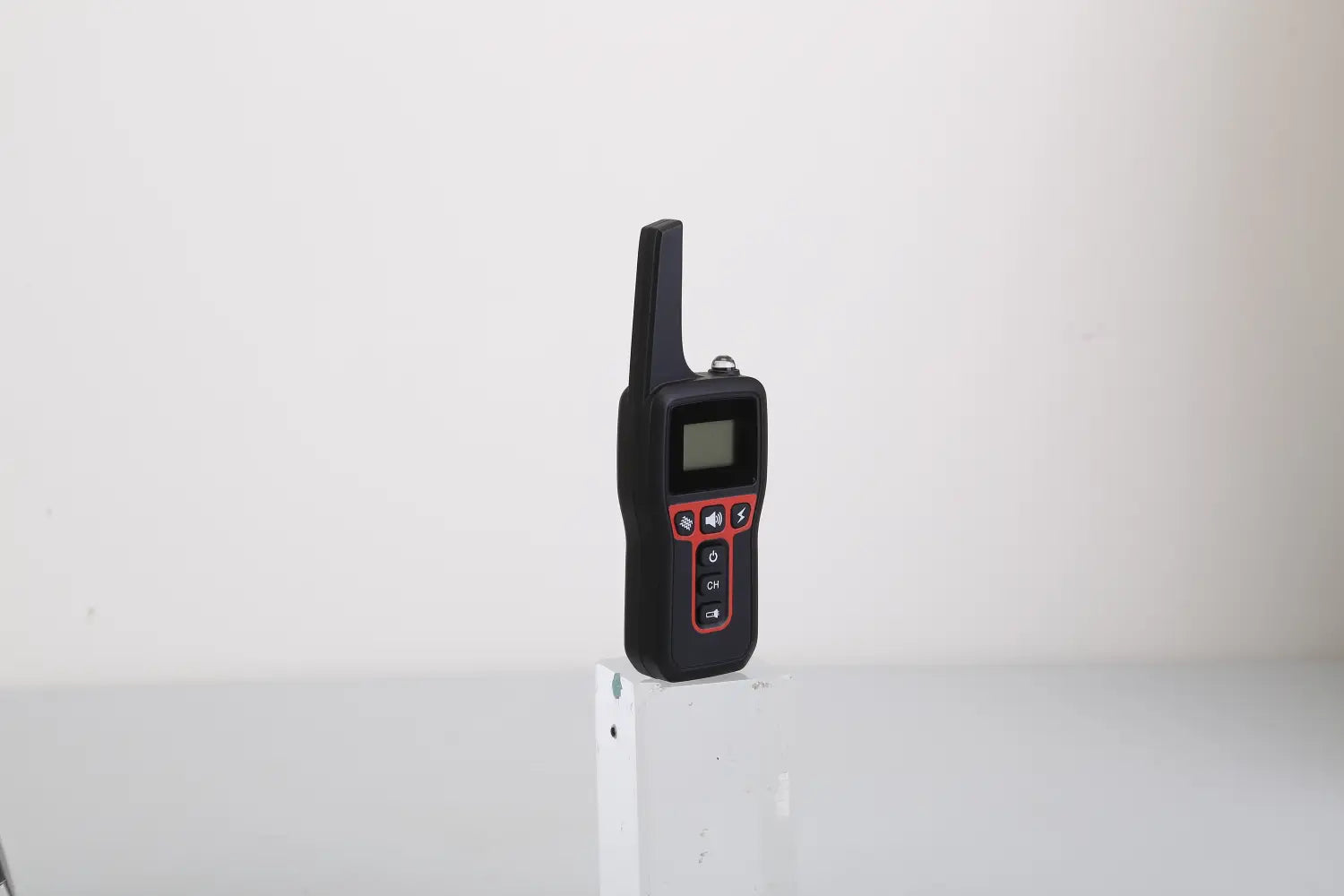black and red handheld two-way radio with a small screen and directional buttons for dog training collar 3280ft waterproof shock system.
