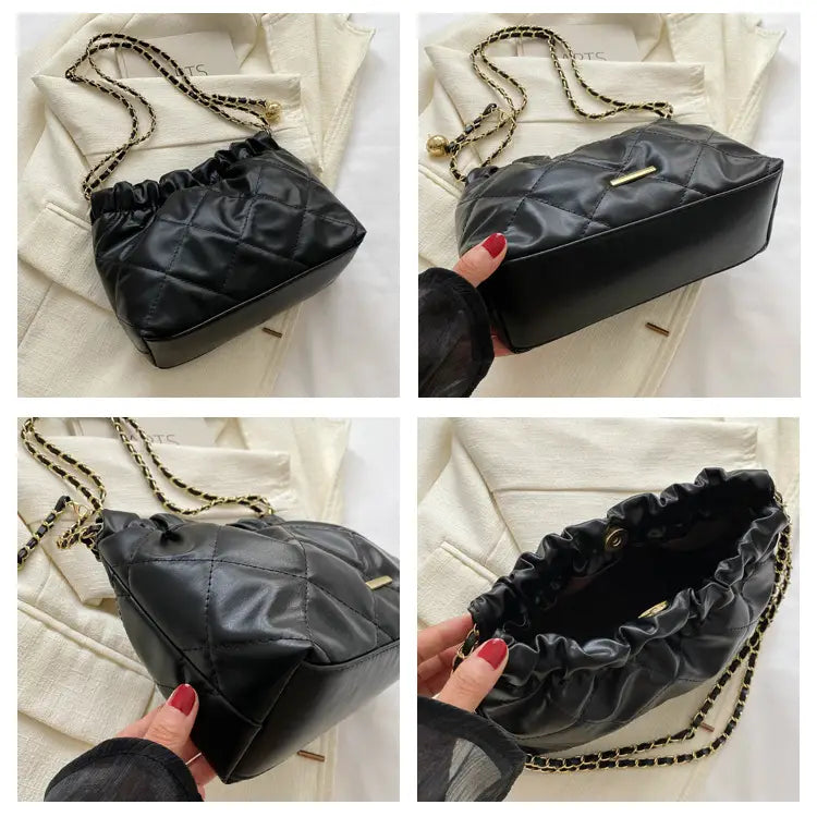 Black quilted faux leather crossbody bag with gold-tone chain strap and drawstring closure.