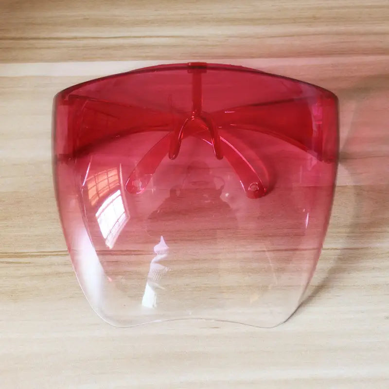 Multifunctional anti-splash iridescent shield sunglasses featuring a red gradient face shield with a transparent lower half and molded plastic frame.