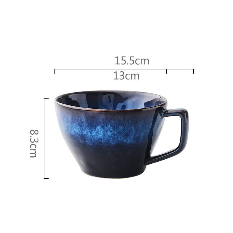 a ceramic coffee mug with a deep blue gradient glaze transitioning from navy to cobalt featuring a sturdy handle and smooth glossy finish in a ceramic coffee mug and saucer set in deep blue glaze