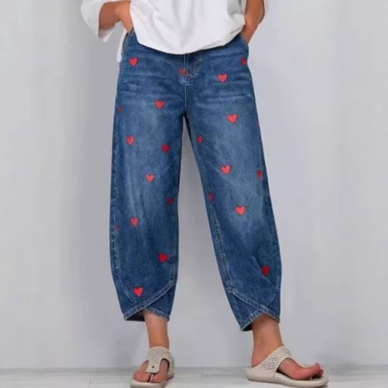 blue denim pants for women featuring red heart embroidery on the front