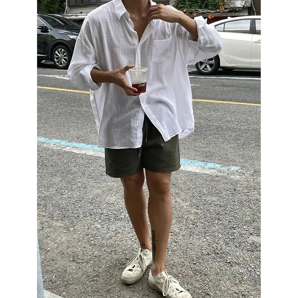 A Korean style white linen button up shirt with a relaxed fit and chest pocket.