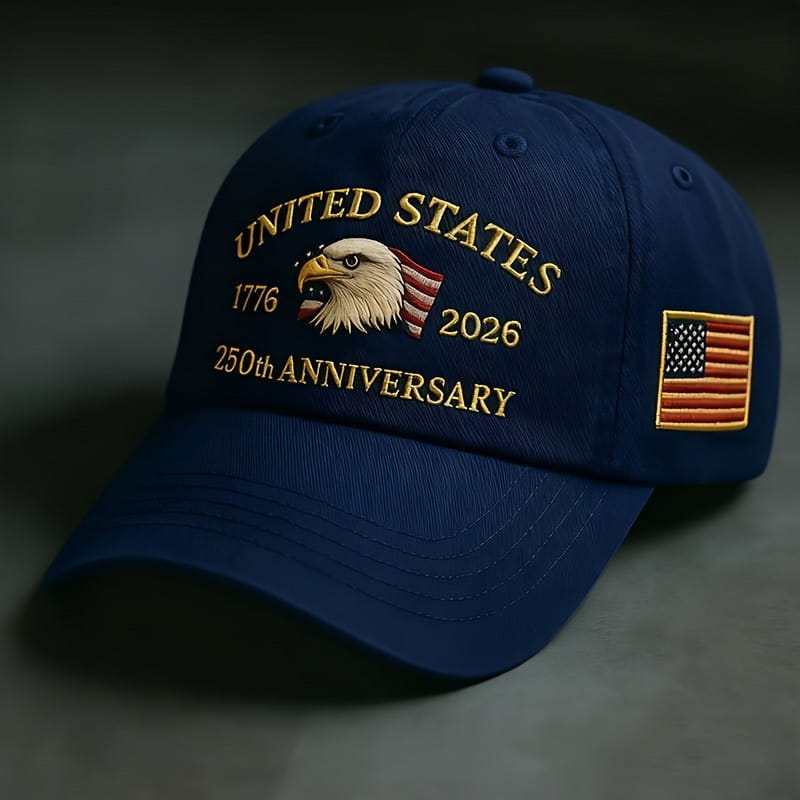 Navy blue usa 250th anniversary embroidered baseball cap featuring gold text embroidery, a bald eagle with an American flag banner, and a small side patch.