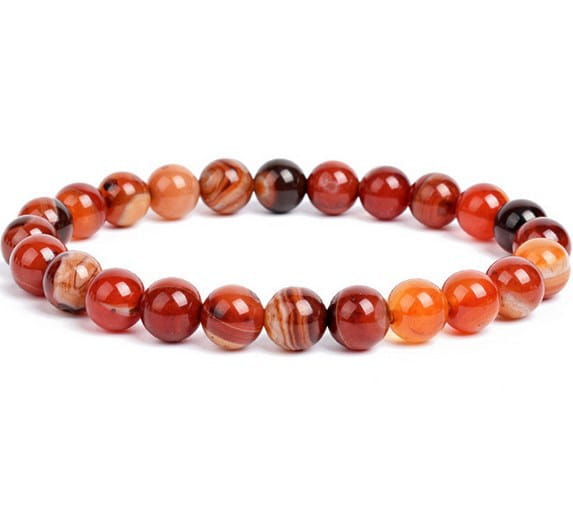 A unisex 8mm polished carnelian bead bracelet featuring a smooth round design with a natural gradient of warm orange and deep red hues and subtle marbled patterns.
