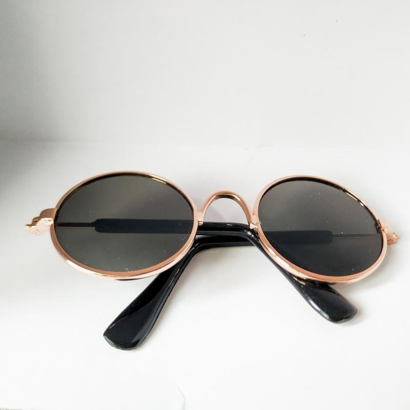 Rose gold metal round cat sunglasses with rose gold frame dark gray mirrored lenses and black temple arms.