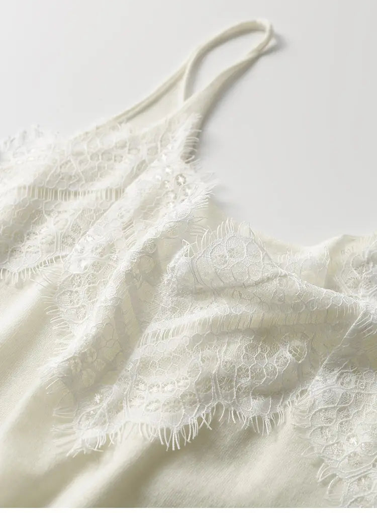 A delicate off-white lace trim camisole top with thin straps and intricate floral lace patterns.