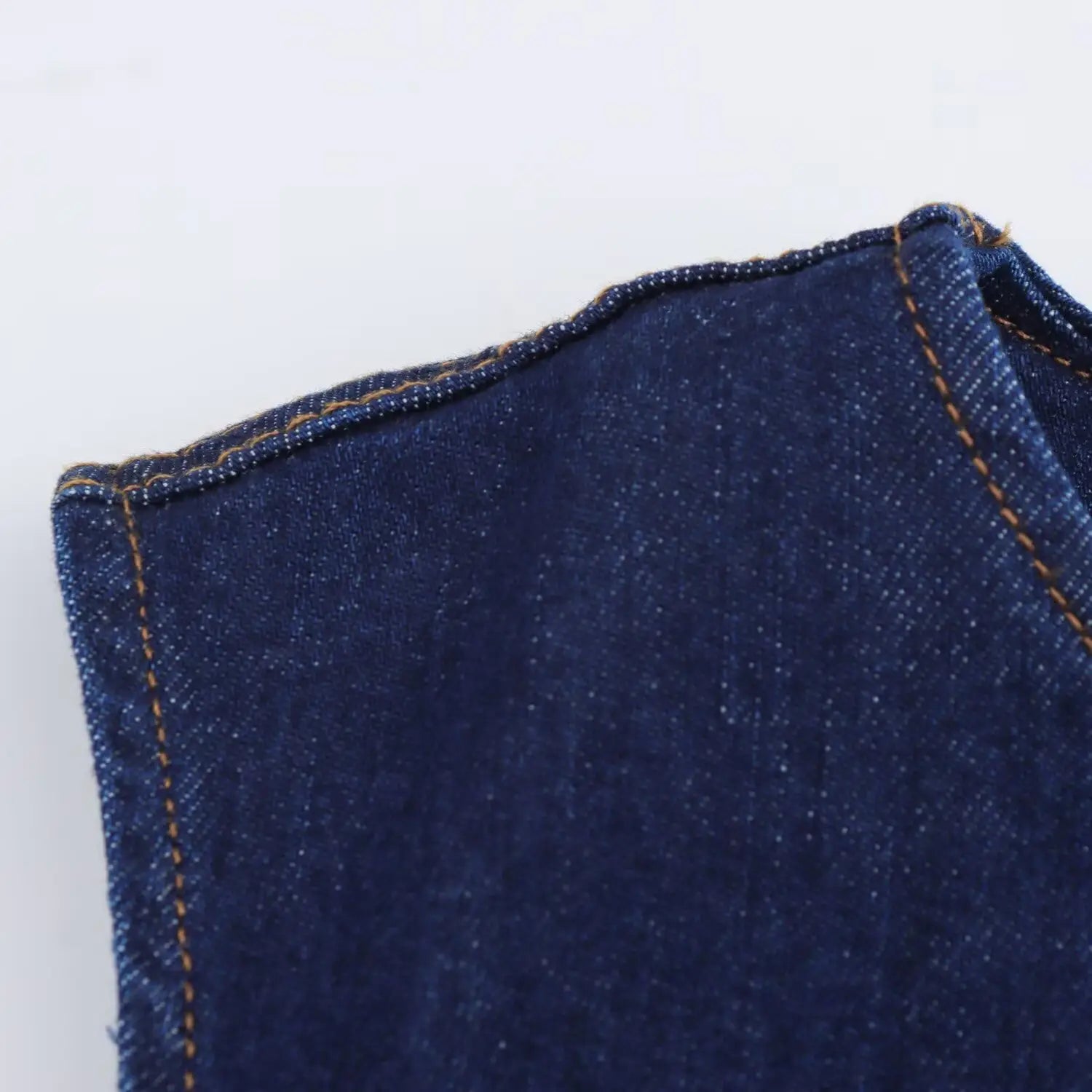navy crew neck sleeveless denim a-line dress showing dark blue denim fabric with visible stitching along the seam