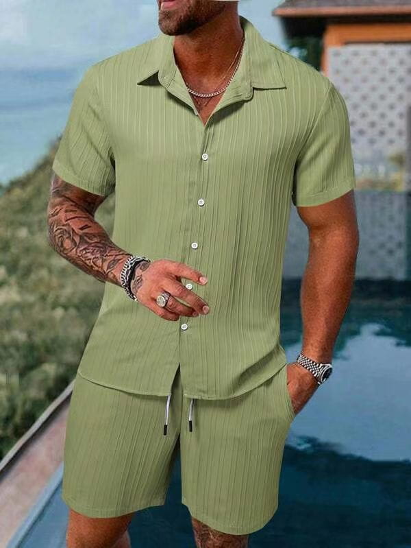 A man wearing a light green men’s ribbed short sleeve shirt and matching shorts beach set with vertical ribbed texture.