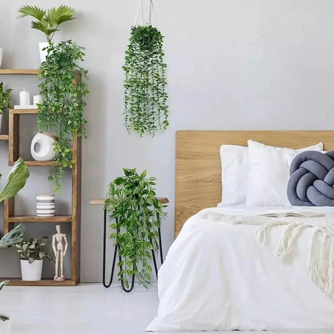 A hanging green artificial plant with cascading leaves suspended by white cords from the artificial hanging plants 3 pack fake trailing greenery collection.