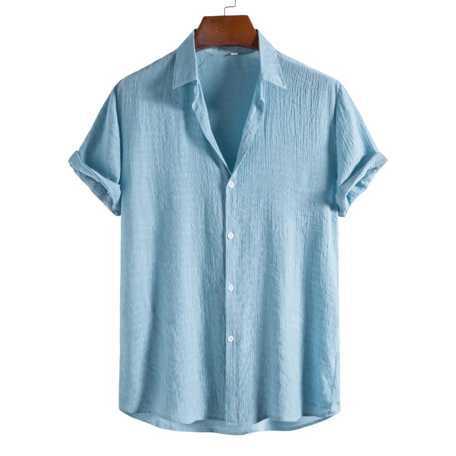 Light blue men’s minimalist short sleeve button-up shirt with textured, slightly wrinkled fabric and rolled cuffs.