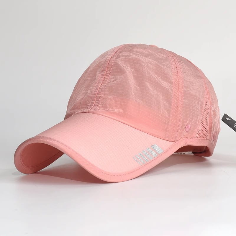 A soft pink quick-drying running hat sports sun cap featuring a lightweight design with a mesh back and subtle reflective branding on the brim.