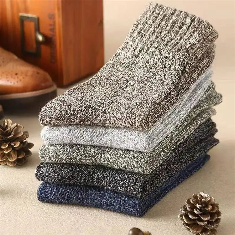 Stack of cozy heathered knit men’s rabbit fur winter socks in muted gray and navy tones.