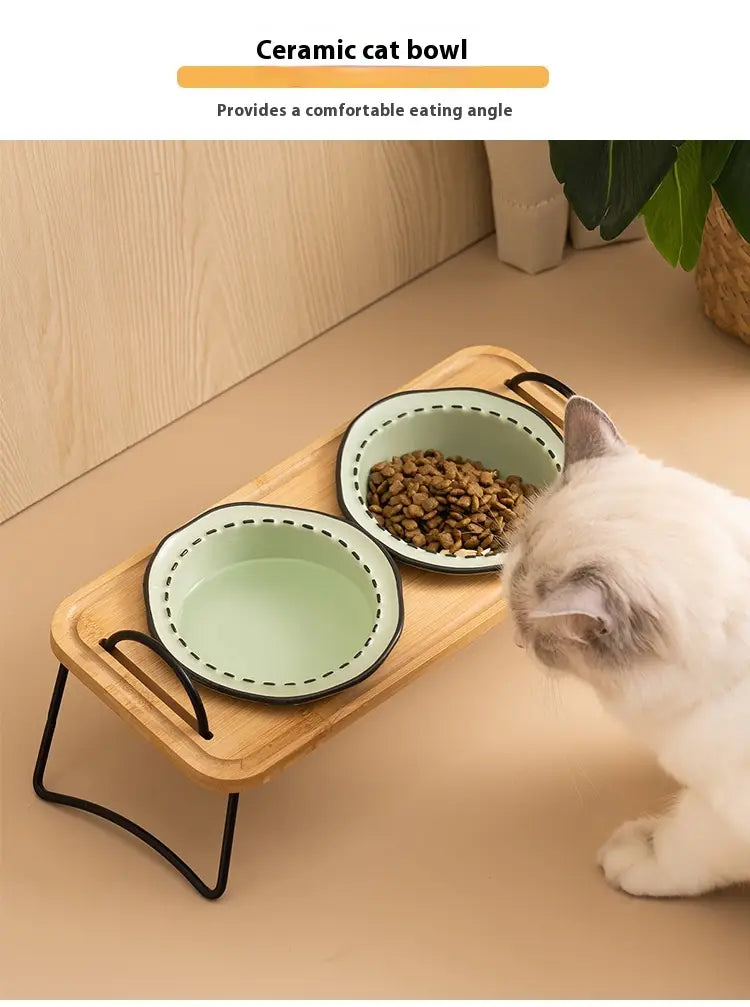 Elevated ceramic cat bowl wooden stand featuring light green ceramic bowls with black rims and dotted detailing placed on a wooden tray.