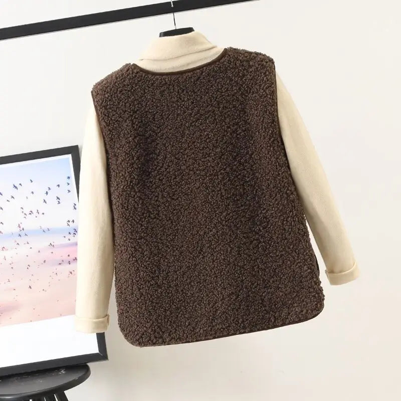 Brown faux fur plush fleece vest for women worn over a cream-colored long-sleeved top suitable for cozy winter outerwear.