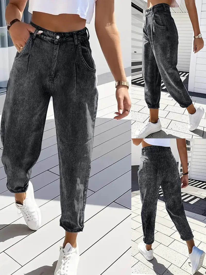 Plus size retro washed tapered denim jeans in dark gray high waisted denim with a faded wash and cuffed hems.