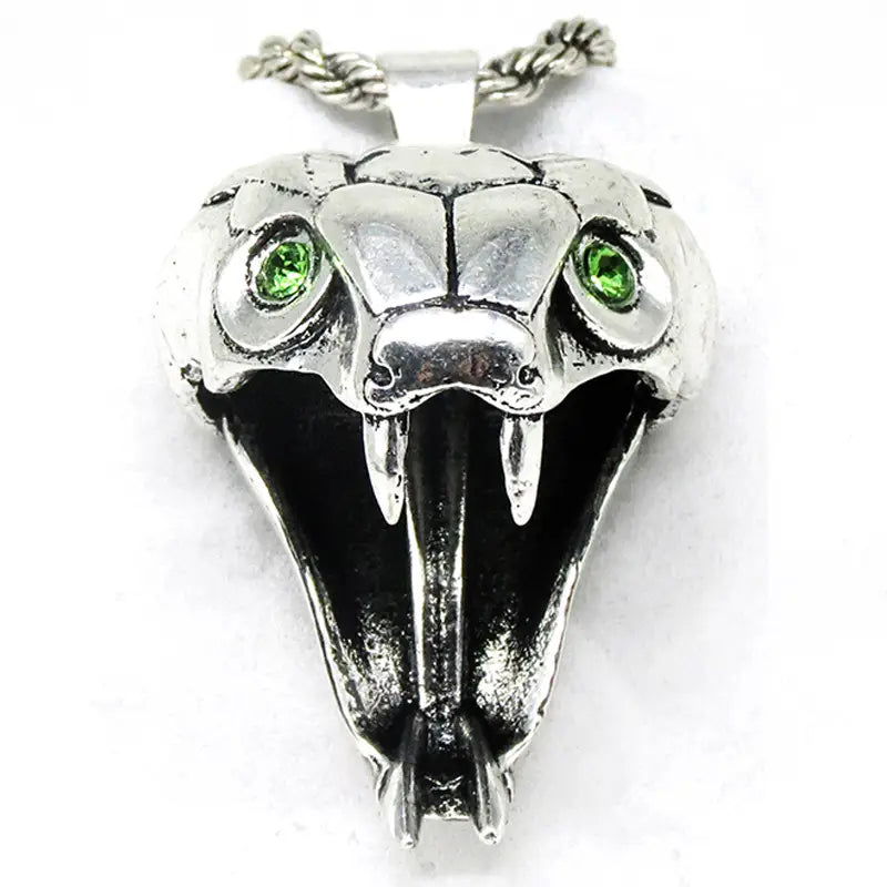 Silver snake head pendant with green gemstone eyes and sharp fangs attached to a twisted rope chain in a geometric wild game animal pendant chain necklace.
