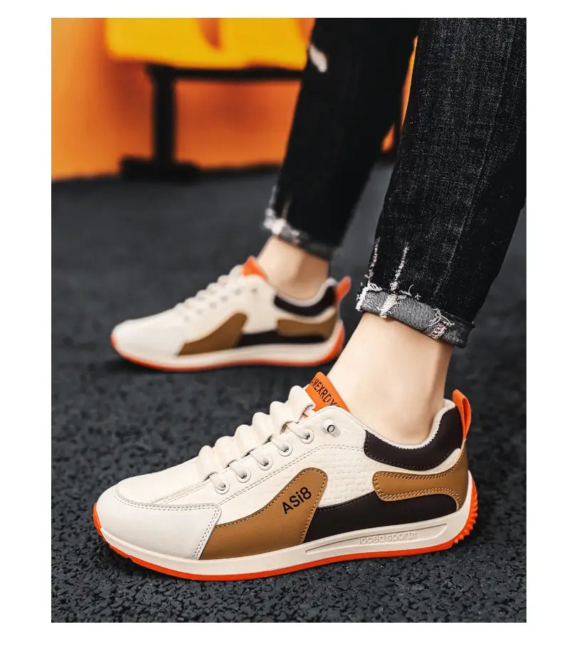 white brown and black men’s casual sports sneakers with orange accents on the soles and heel tabs made of non-slip microfiber material