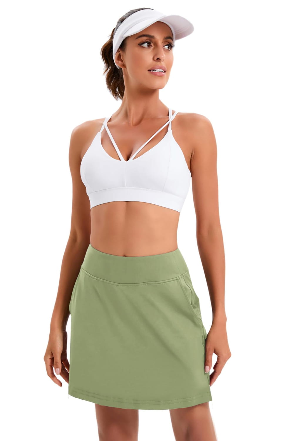 white sports bra with crisscross straps and a flattering scoop neckline paired with paisley high-waisted athletic tennis skirt for activewear use