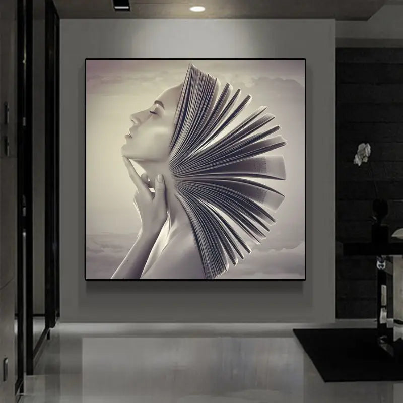 Arte mural moderno en lienzo con marco negro titulado "book head woman profile"; presenta una impresión en escala de grises de una mujer de perfil con el rostro parcialmente oculto por un libro abierto desplegado detrás de ella.