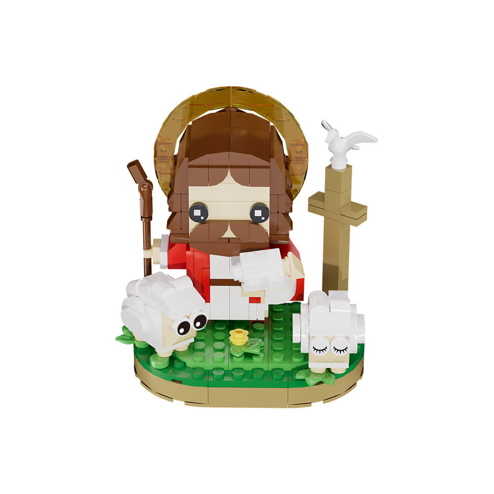 Un mignon modèle anguleux de blocs de construction représentant Jésus berger, aux cheveux bruns et à la barbe, portant une robe rouge et blanche, debout à côté de deux moutons blancs sur une plaque de base verte.