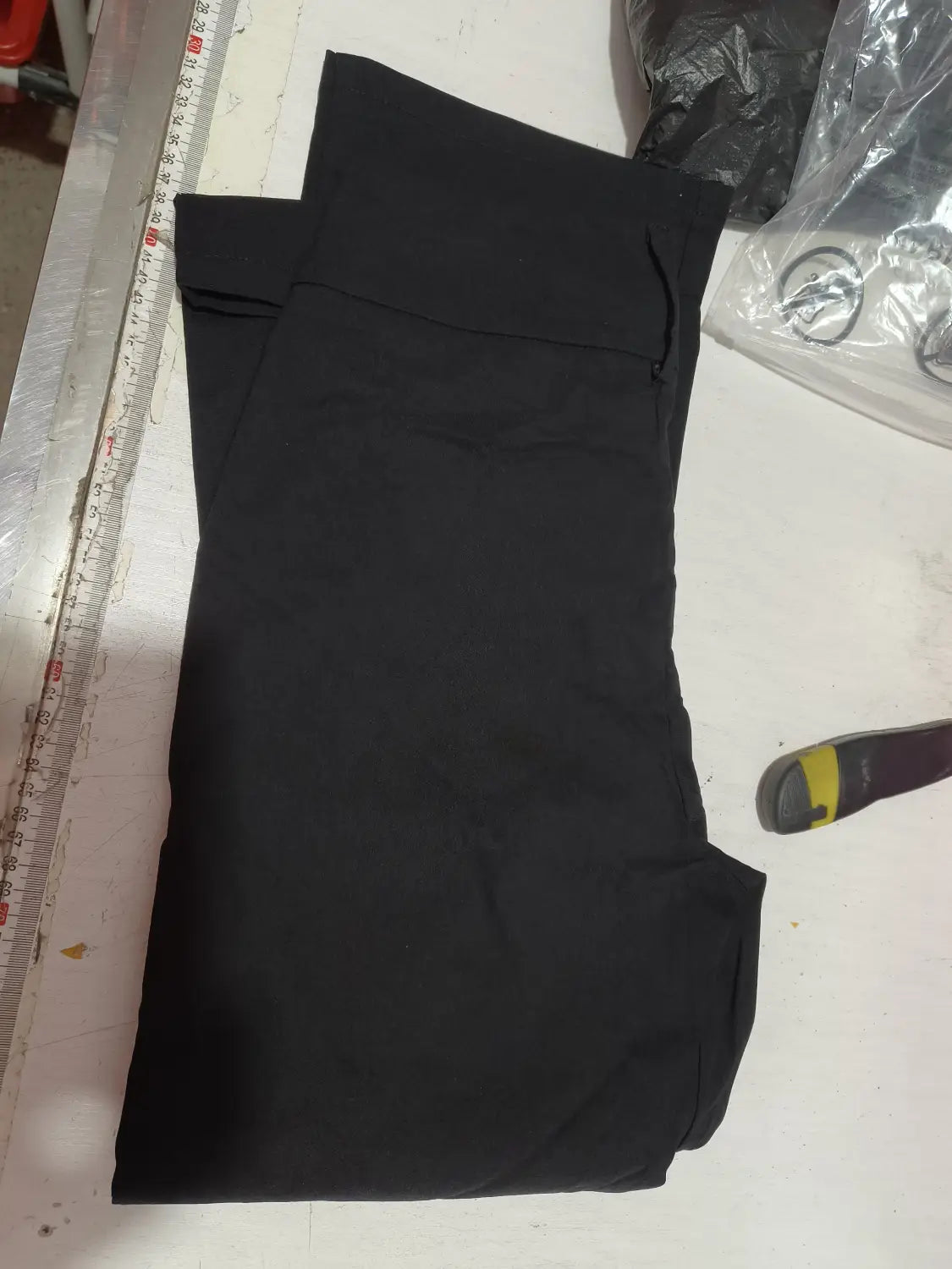 black wide leg work pants with smooth matte fabric and clean-cut seams designed for high waist casual wear