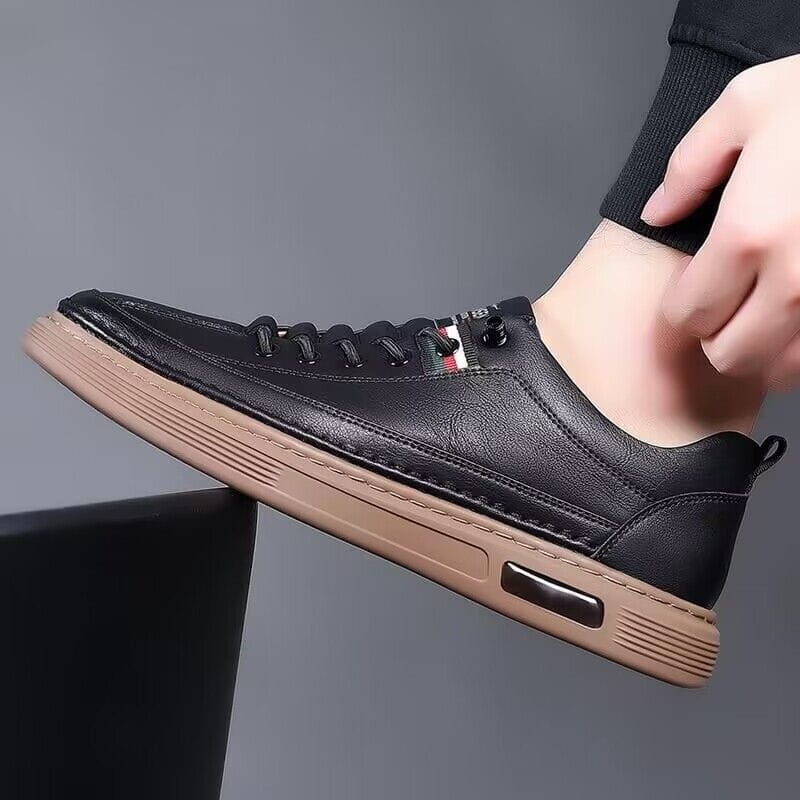 Schwarzer Ledersneaker im Casual-Stil mit beiger Gummisohle und einer Luftpolster-Einheit, entworfen als Ledersportschuh im Freizeitschuh-Look mit Polsterung.