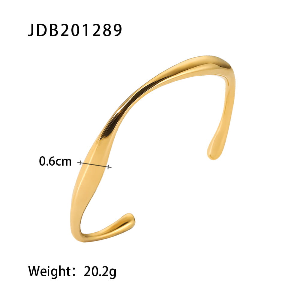 Gold plated stainless steel bangle bracelet with gold-toned sleekly curved open cuff design and smooth metallic finish.