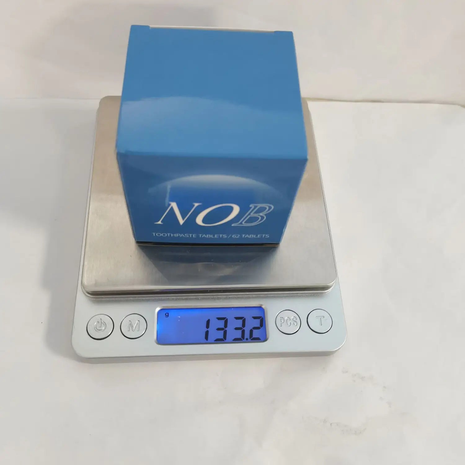 Blue rectangular box of Nob solid toothpaste tablets containing 62 portable breath mint pieces.