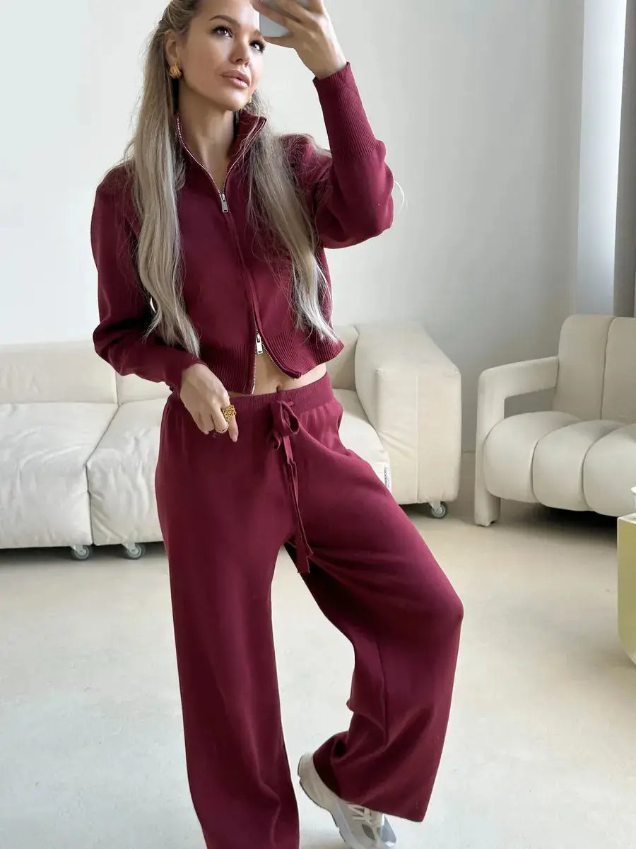 Women’s maroon knit zip-up cardigan and matching wide-leg sweatpants set displayed from the front showcasing cozy material and relaxed fit.