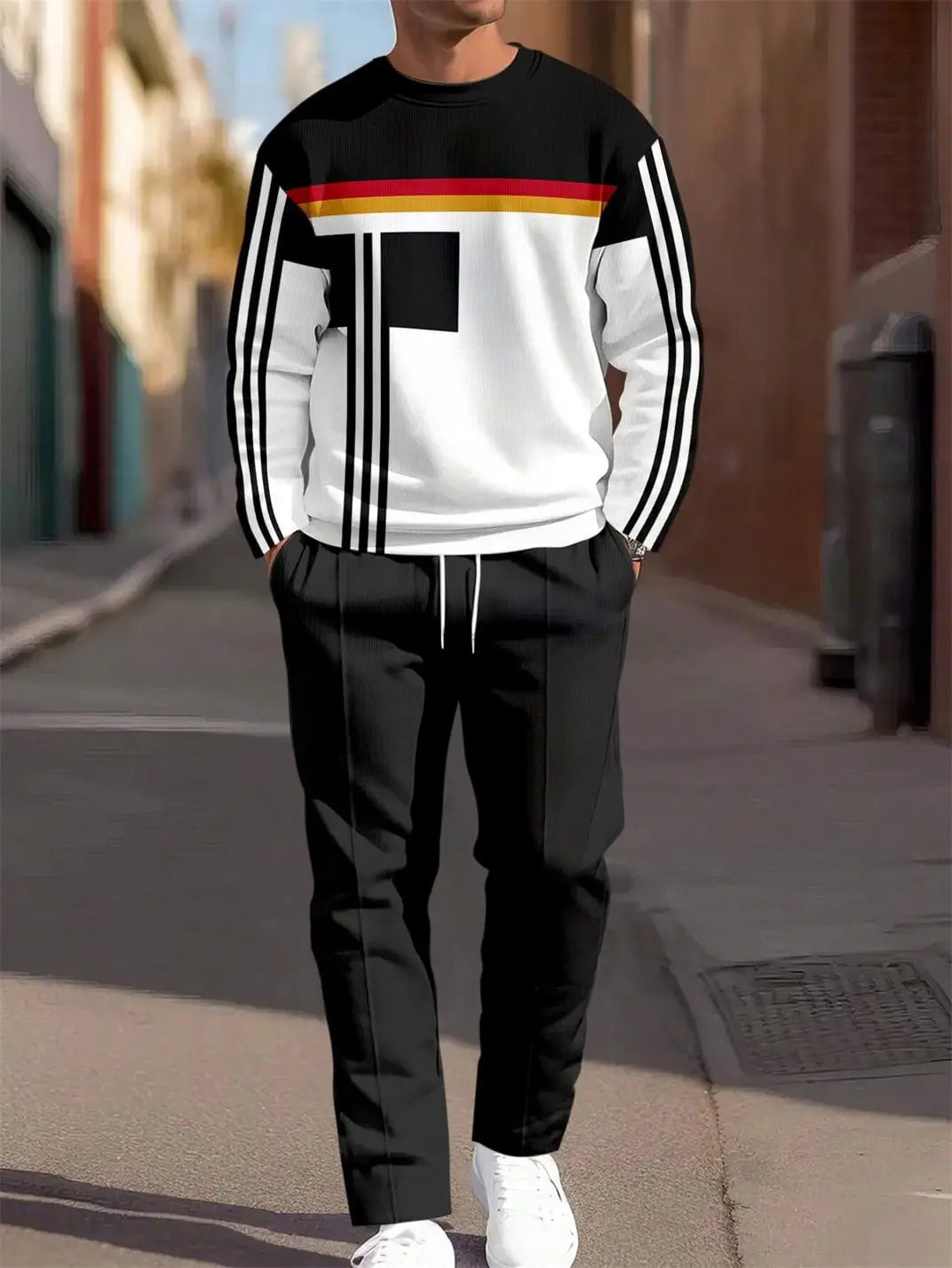 Ensemble sweat à carreaux et pantalon pour hommes, comprenant un sweat-shirt à manches longues noir et blanc, avec des rayures horizontales marquées en rouge, jaune et noir sur la poitrine.