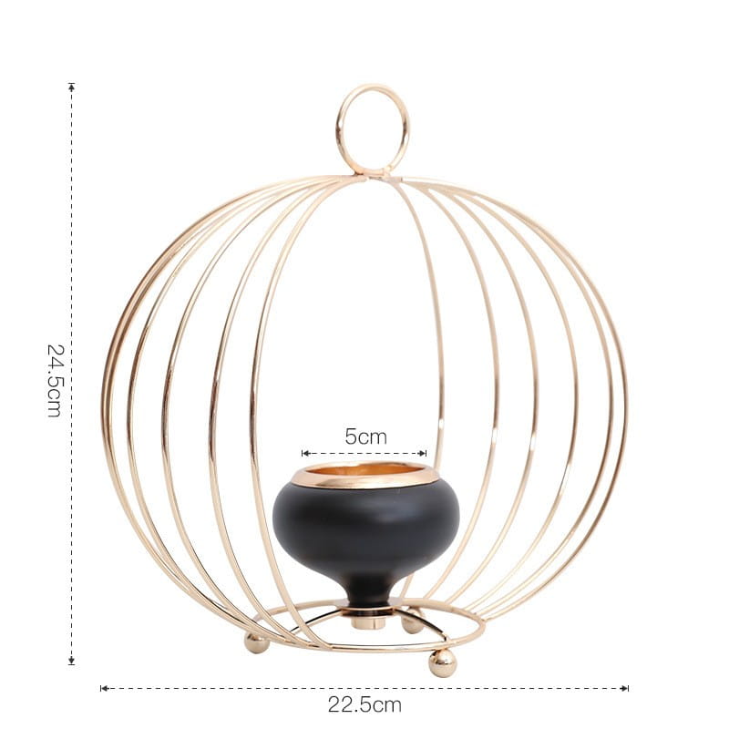 Gold geometric wire cage candle holder featuring a black ceramic base inside.