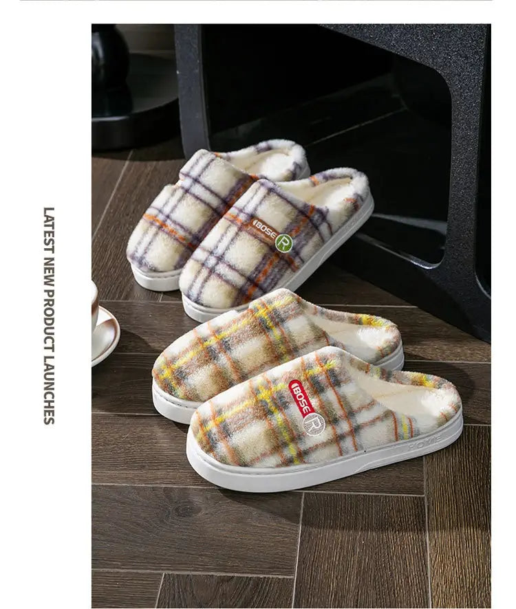 Unisex plaid fleece lined indoor slippers with white rubber non slip soles and a small red logo patch.