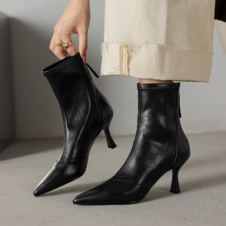 Black leather cowhide ankle boots with pointed toe and slim high stiletto heel featuring a side zipper.