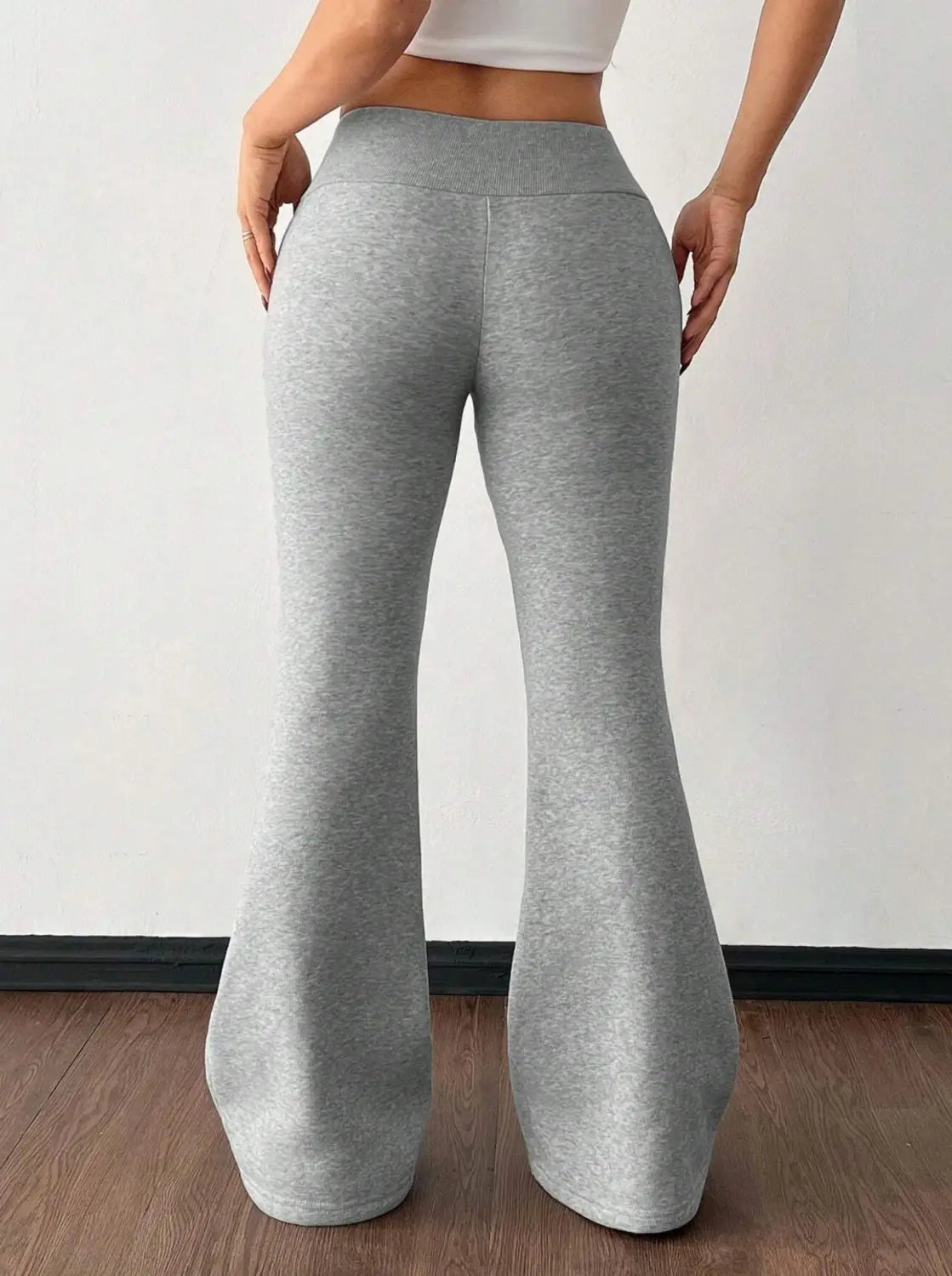 Gray heathered fleece lined high waist flared sweatpants made from soft stretchy fabric for comfortable wear.