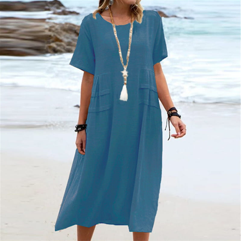 A flowing blue linen loose short sleeve midi beach dress with front pockets for women.