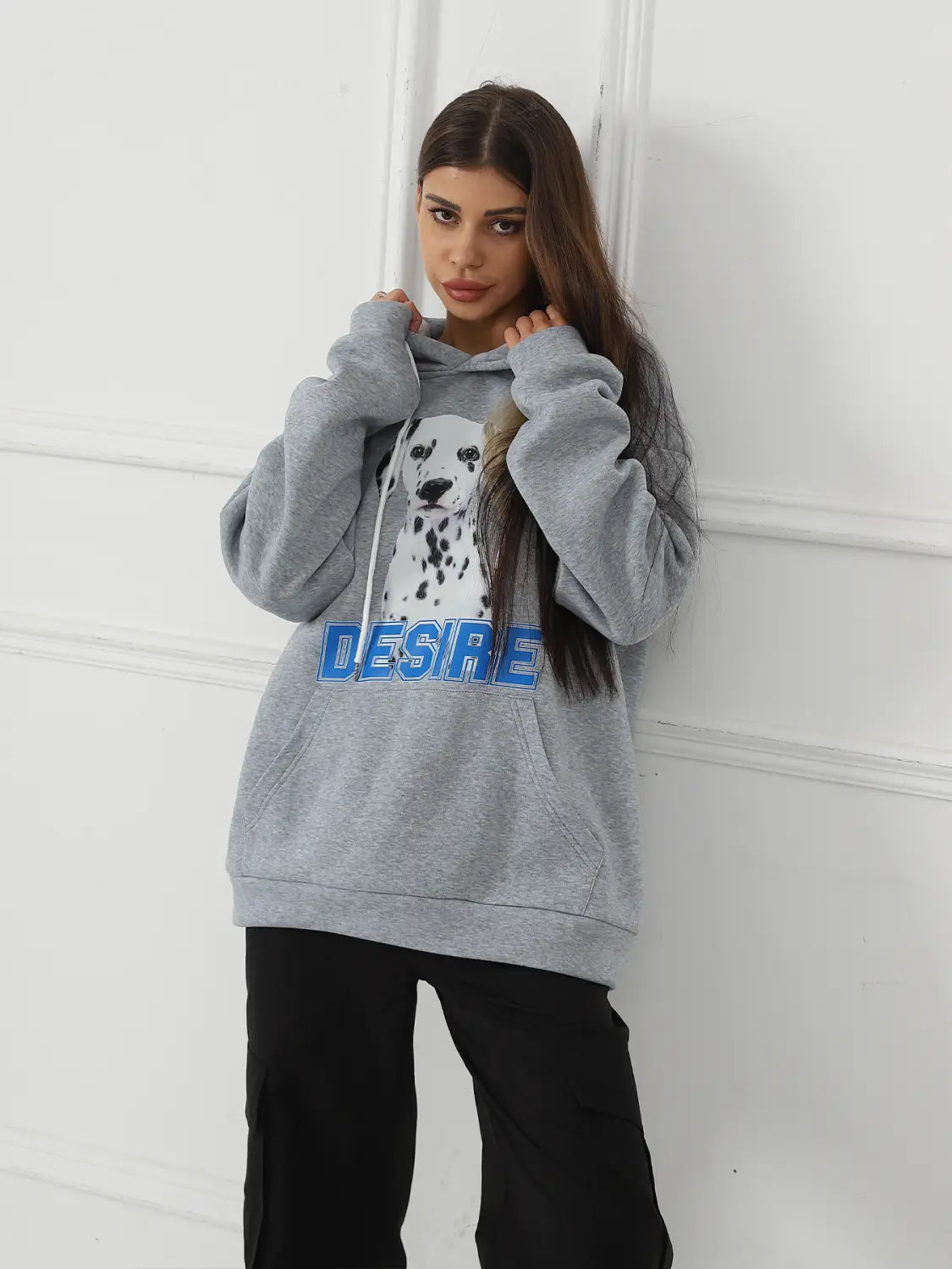 Gray women’s hoodie featuring a white dalmatian graphic and blue desire lettering across the chest with a cat ear hood.