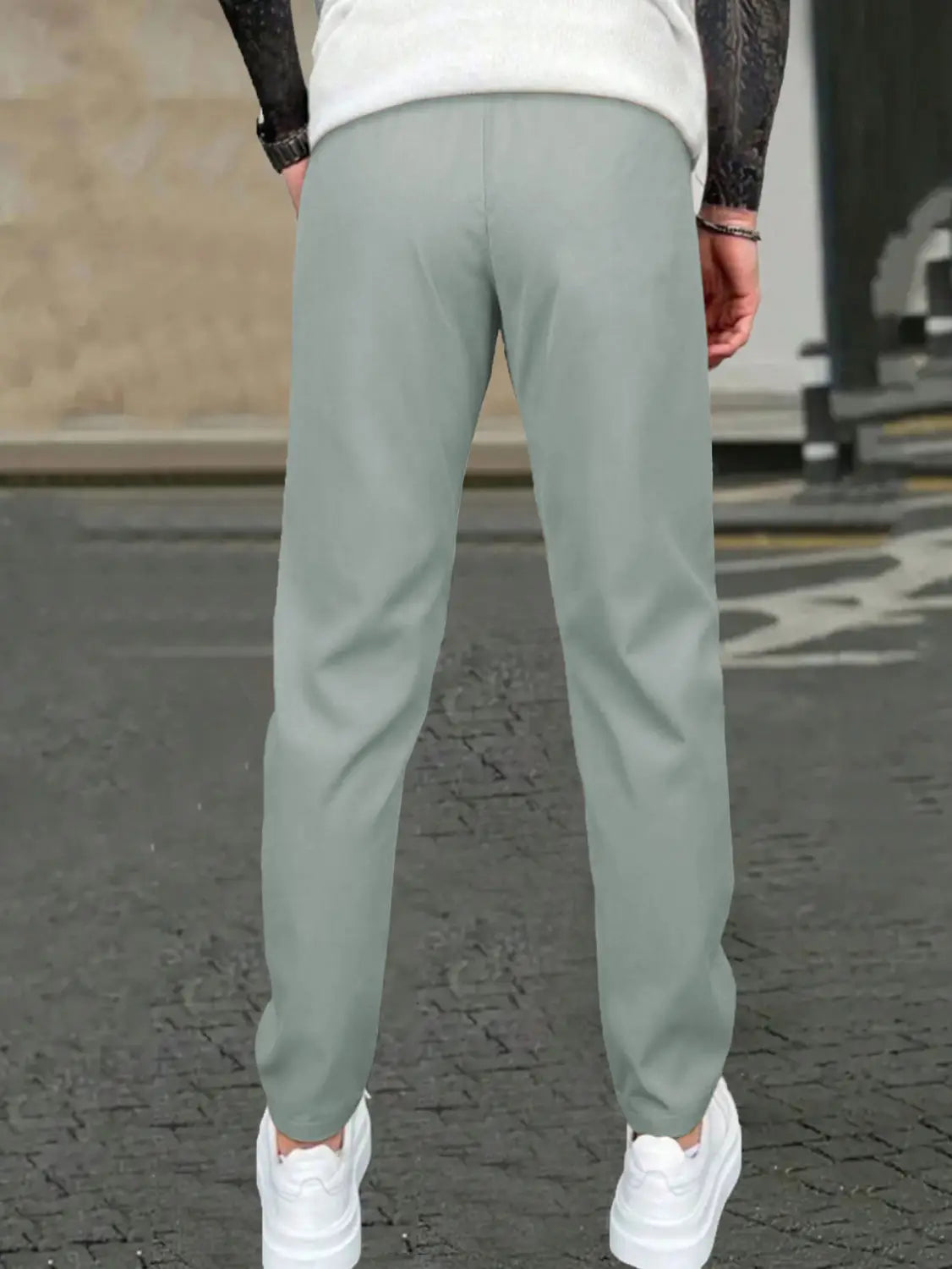 Light green slim fit tapered jogger pants with drawstring made of smooth modern fabric.