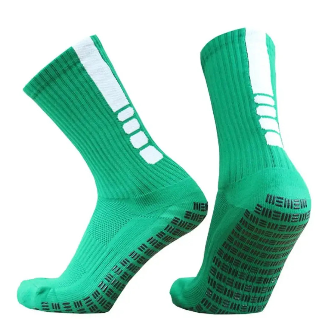 Vibrant green grip soccer socks with white stripes and black textured non slip soles designed for athletic use.
