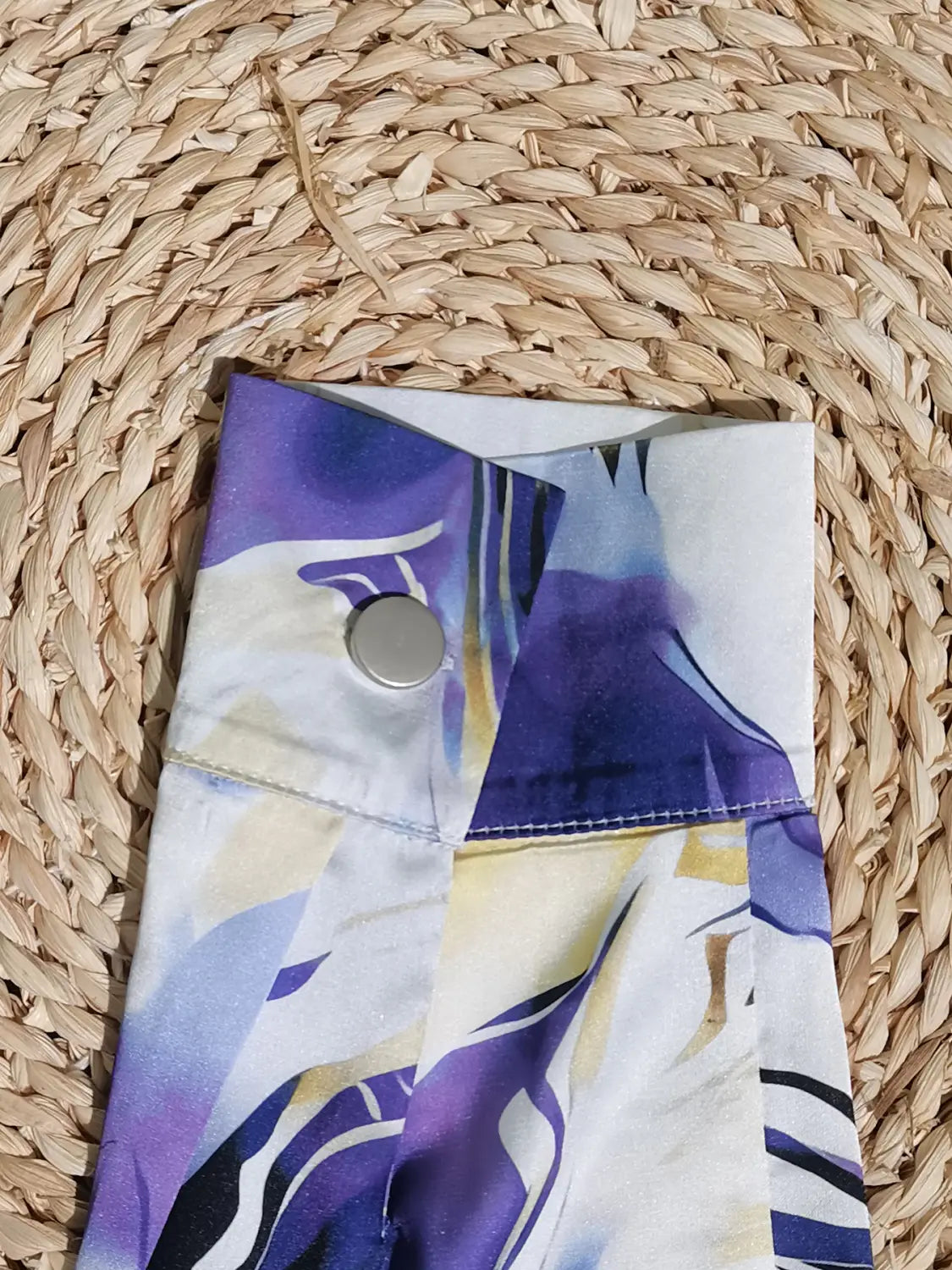 women’s marble print satin long sleeve button blouse featuring a purple and white abstract-patterned fabric sleeve with a silver button detail