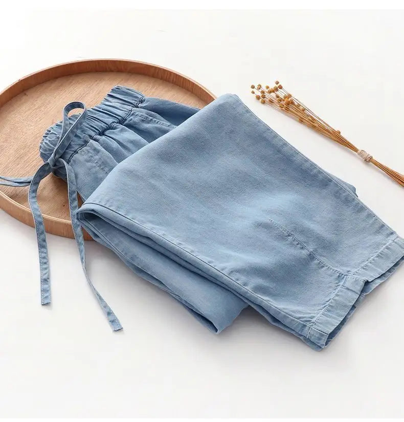 light blue denim harem jeans high waisted drawstring pants featuring an elastic waistband for adjustable comfort