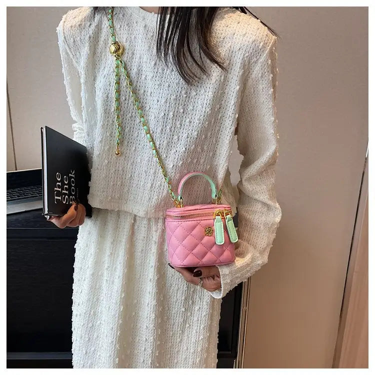 pink quilted diamond chain crossbody bag with pu leather featuring a mini design and mint green chain strap with matching handle accents