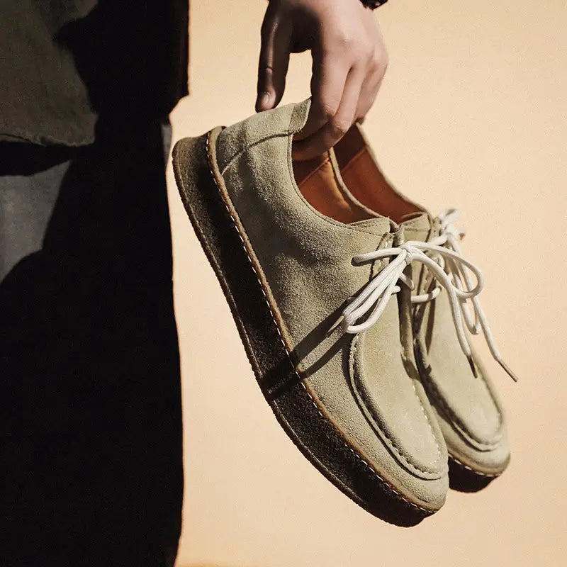 Suede British style casual lace up leather shoes in olive green with white laces and a tan interior.