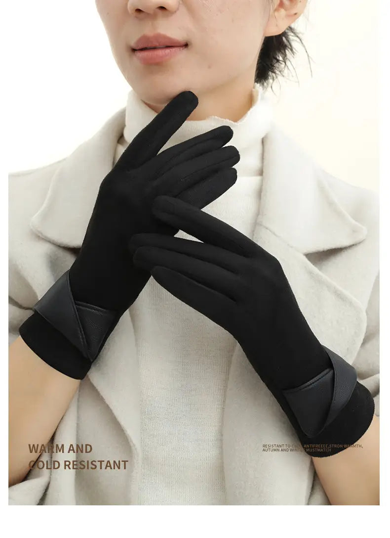 Black touchscreen fleece lined bow gloves shown from the back with sleek smooth fabric and contrasting leather like cuffs.
