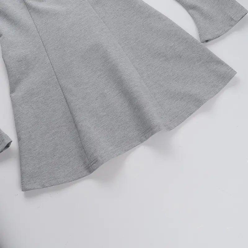 A soft heather gray long-sleeved top with a relaxed fit and subtle seam detailing as part of a slim fit long sleeve a line flared dress.
