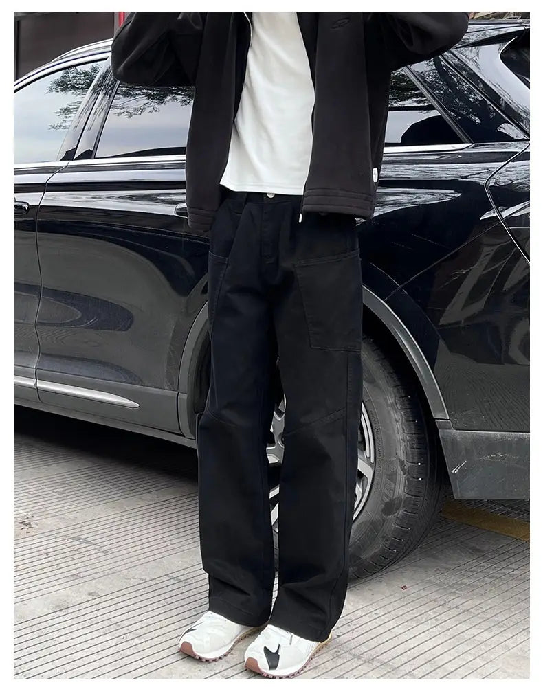 black straight-leg trousers with a relaxed fit and visible stitching details shown as part of olive green cargo pants mens cotton workwear collection